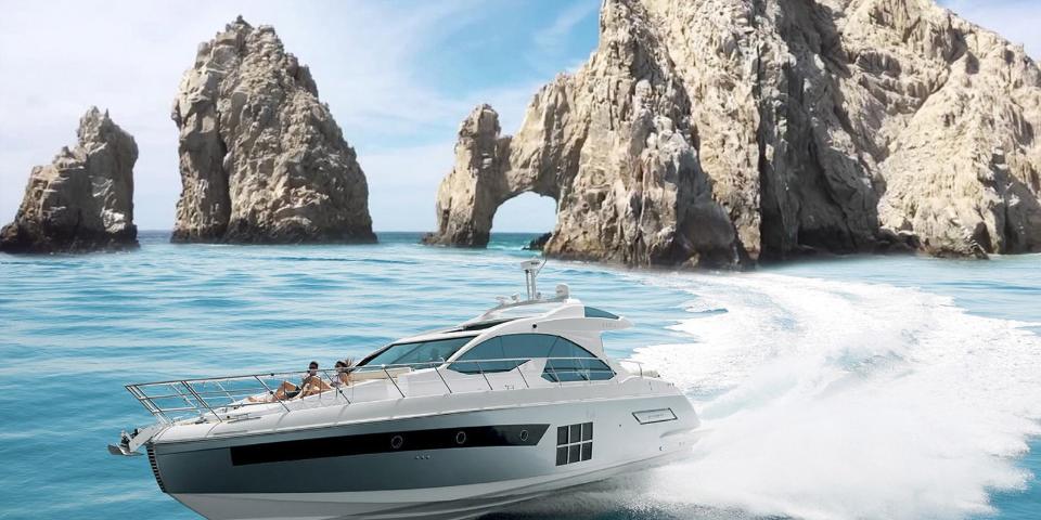 White motor yacht cruising near El Arco and the granite rocks of Land's End in Cabo San Lucas