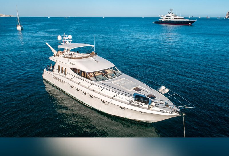 70-foot motor yacht at anchor in calm blue water