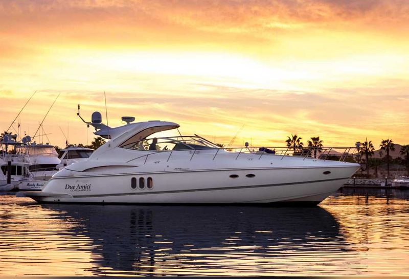 52-foot express cruiser moored in a marina at sunset