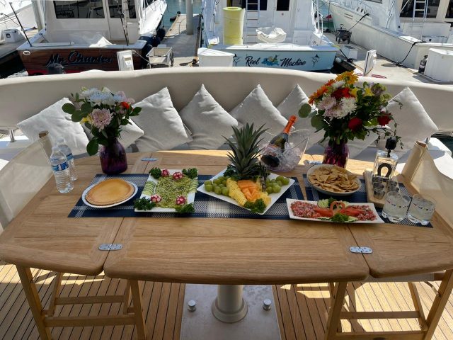 Lunch spread of fruit, salads and appetizers on a yacht table