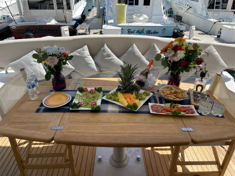 Buffet of fruit, salads and appetizers set out on a yacht's deck table