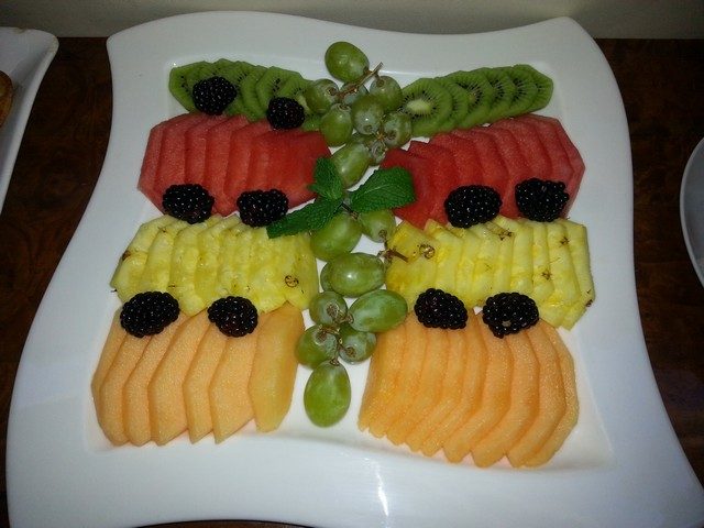 Tray of fresh sliced fruit and berries on a yacht